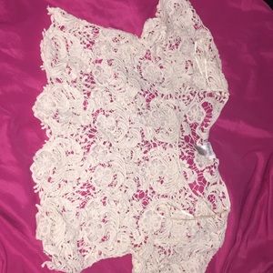 A cream white crochet crop top